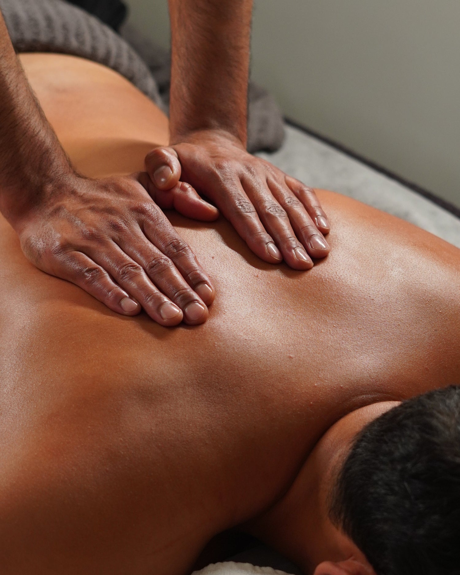 Person receiving a massage on a neutral background